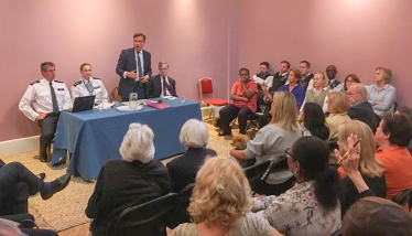 Greg Hands addressing a recent public meeting on crime in Chelsea